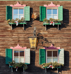 Retro style wooden windows on sunny wall of residential house in zell am see of winter austria