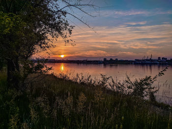 Scenic view of lake against sky during sunset