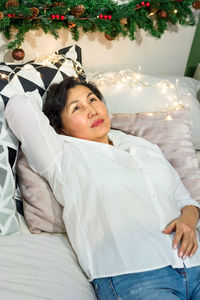 Portrait of young woman sleeping on bed at home