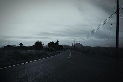 Empty road along trees