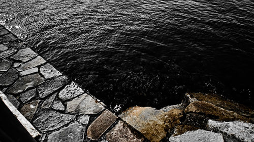 High angle view of water flowing through rocks