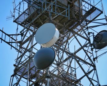 Low angle view of communications tower against sky