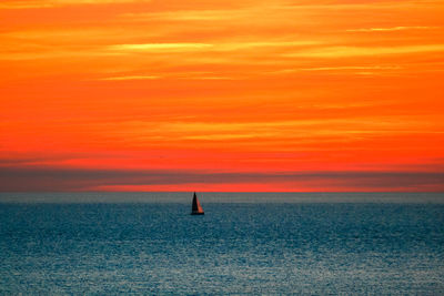 Scenic view of sea against orange sky