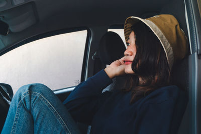 Portrait of woman sitting in car