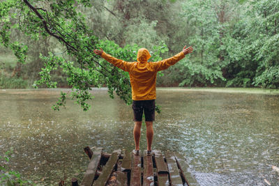 Full length of man standing by lake