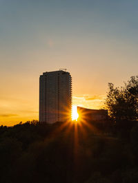 Silhouette buildings against sky during sunset