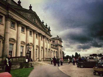 Silhouette of people against cloudy sky