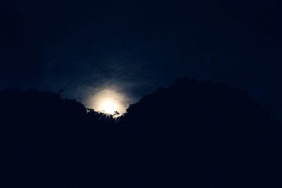 Low angle view of silhouette moon at night