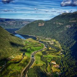 High angle view of road by land against sky