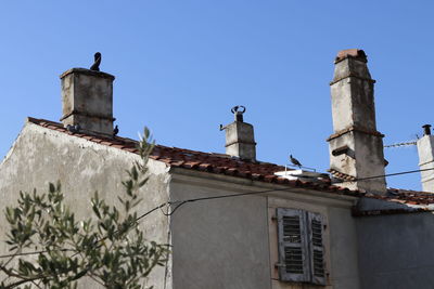 Low angle view of bell tower against clear sky