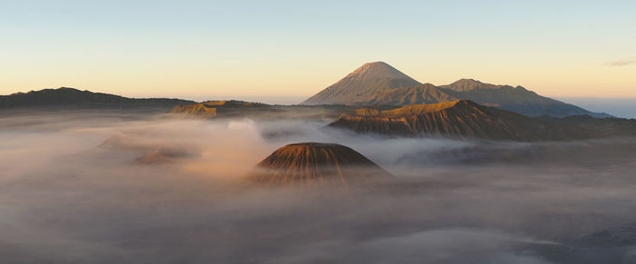 View of volcanic mountain against sky during sunset