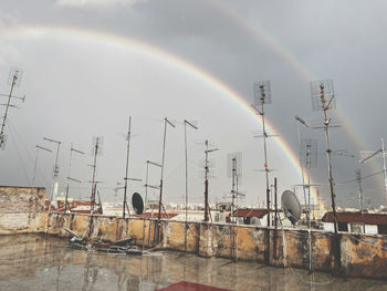 Scenic view of rainbow over buildings in city