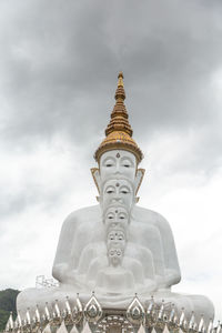 Statue of temple against building