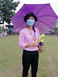 Portrait of woman holding umbrella