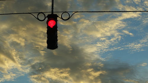 Low angle view of red light against sky