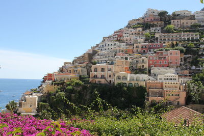 High angle view of townscape by sea against sky