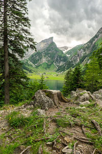 Scenic view of mountains against cloudy sky