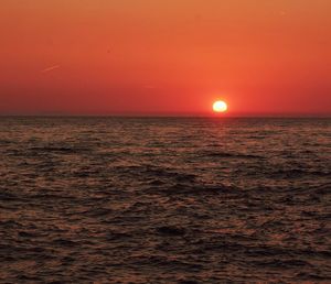 Scenic view of sea against romantic sky at sunset