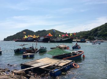 Boats in sea against sky