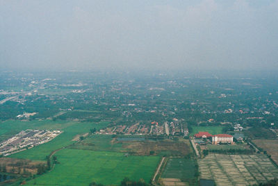 High angle view of buildings on field against sky