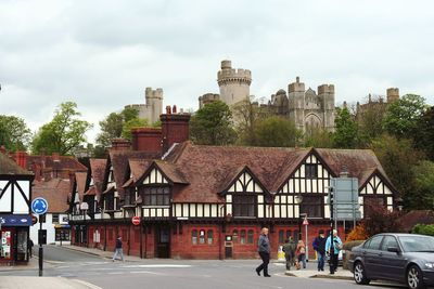 People on road in city against sky