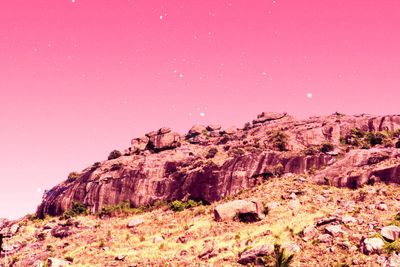 Low angle view of rock formation against sky