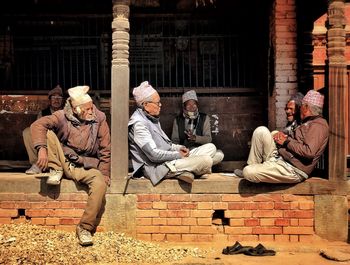 Group of people sitting outside building