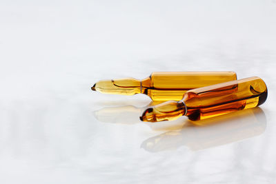 Close-up of yellow bottle against white background