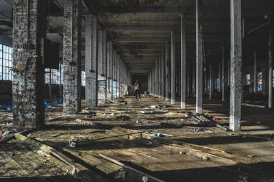 Woman standing in abandoned building