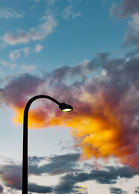 Low angle view of silhouette street light against sky