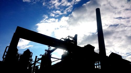 Low angle view of silhouette built structure against sky