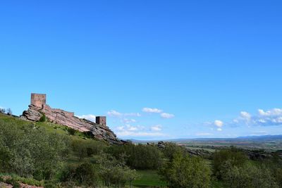 Panoramic view of landscape against blue sky