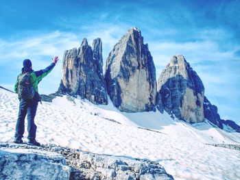 Man hiker with backpack on the tre cime di lavaredo tour. beautiful surroundings at spring time
