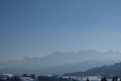 Scenic view of mountains against clear blue sky