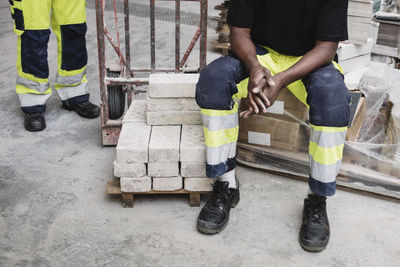 Low section of carpentry students with stacked bricks at site