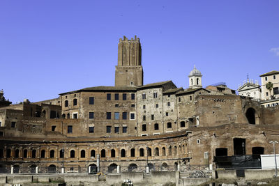 Low angle view of historical building against blue sky