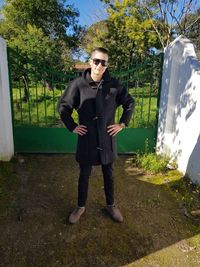 Full length of young man standing against plants