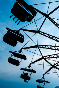 Cropped image of chain swing ride against sky