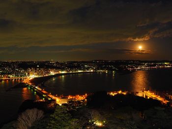 High angle view of illuminated cityscape against sky at night