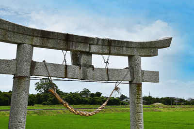 Low angle view of old structure on field against sky