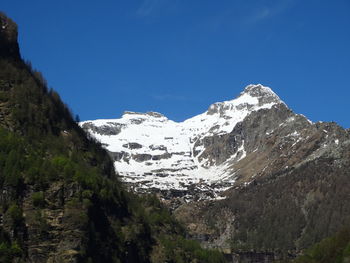 Scenic view of snowcapped mountains against clear blue sky