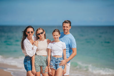 Friends standing at beach