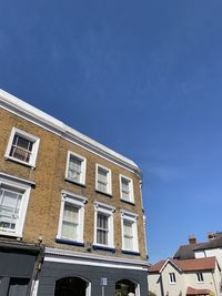 Low angle view of buildings against blue sky