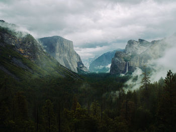 Scenic view of mountains against cloudy sky