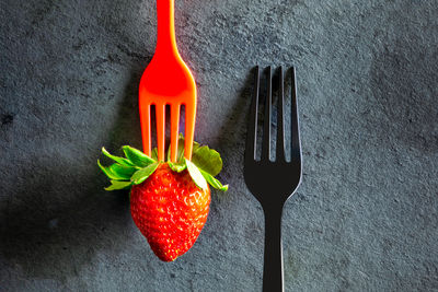 High angle view of strawberries on table against black background