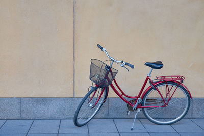 Bicycle parked against wall