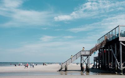 People on beach against sky