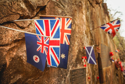 Close-up of flags hanging against built structure