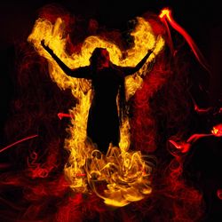 Woman with red light painting at night