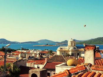 Townscape by sea against clear sky